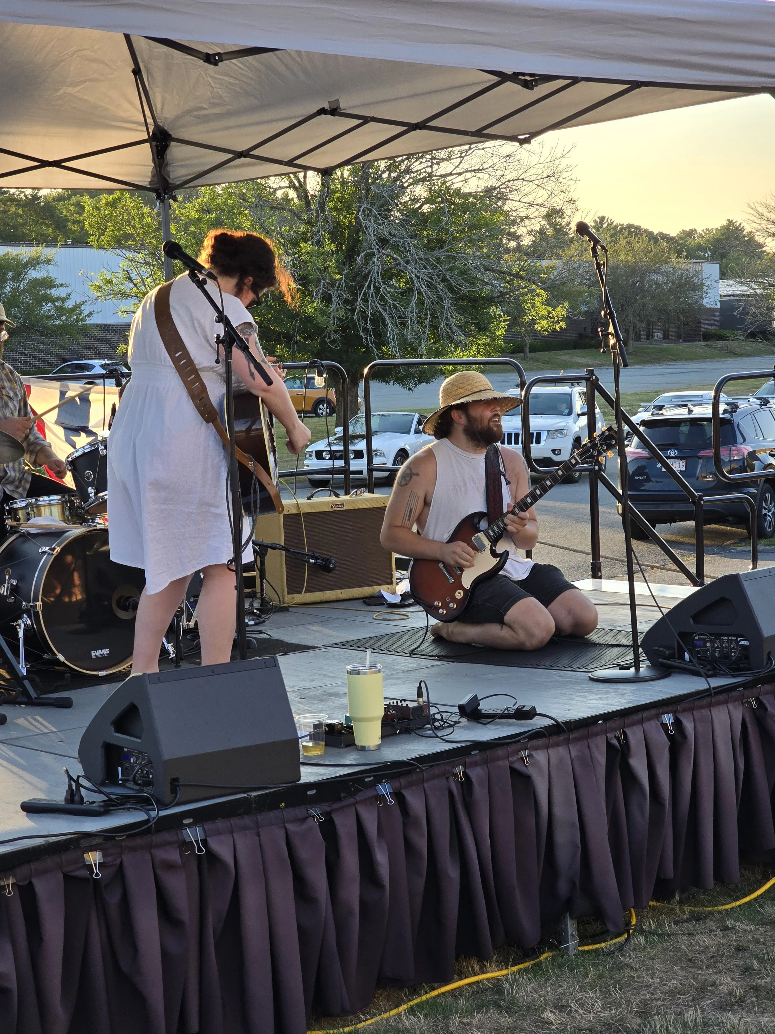 Female lead singer and lead guitarist (playing while kneeling) of the Highwater Haulers.