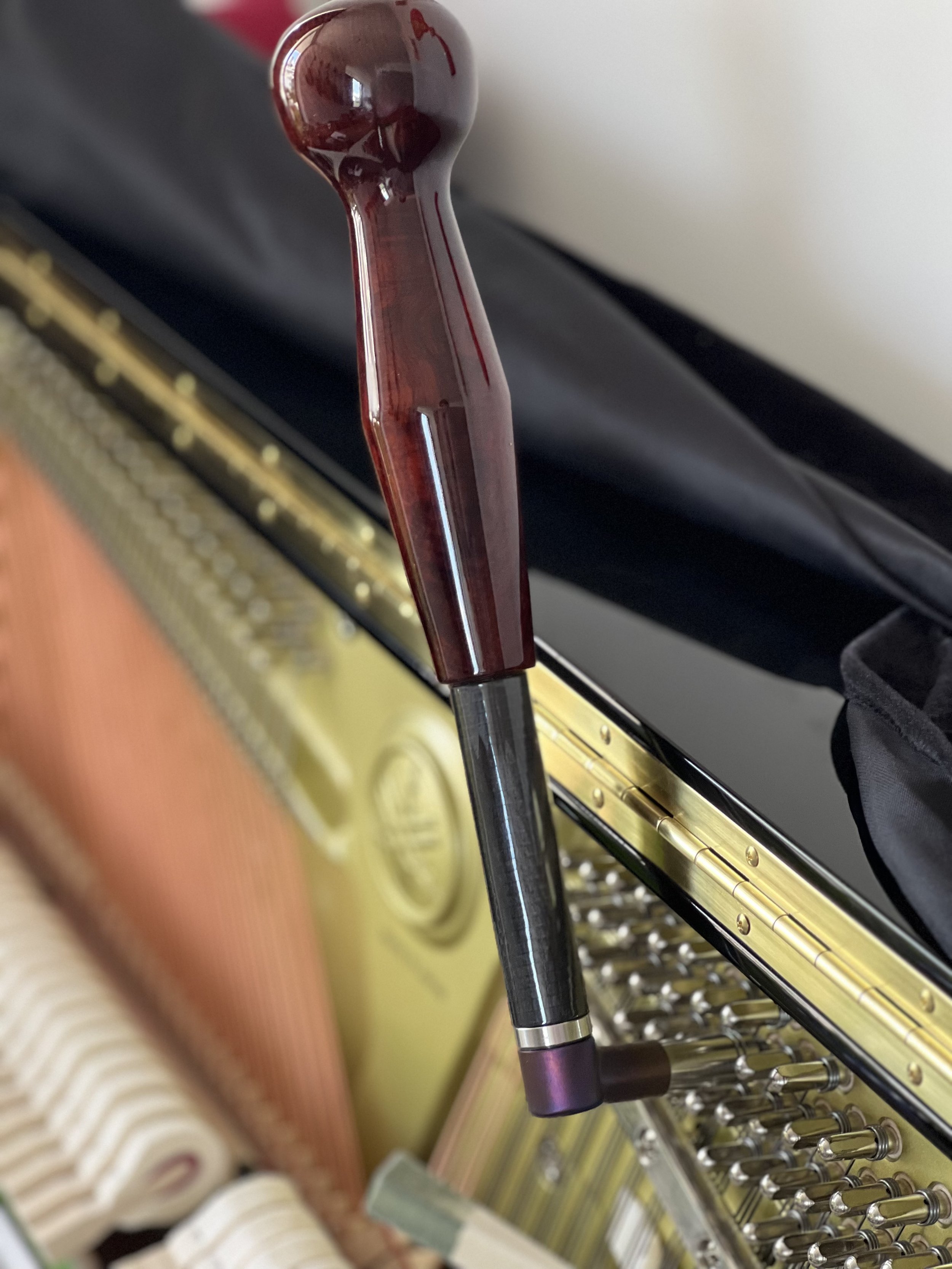 Piano technician tuning an upright piano