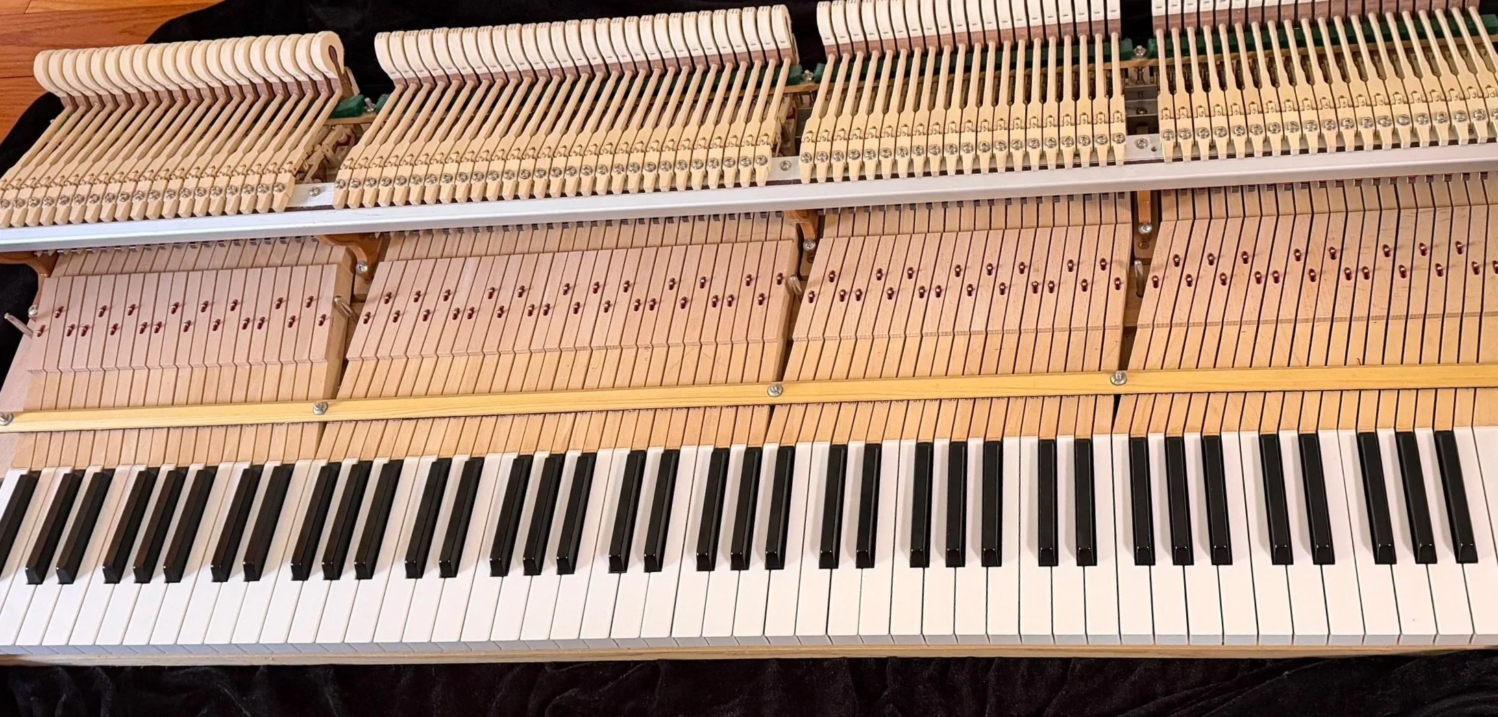 Piano action regulation to improve key response and touch