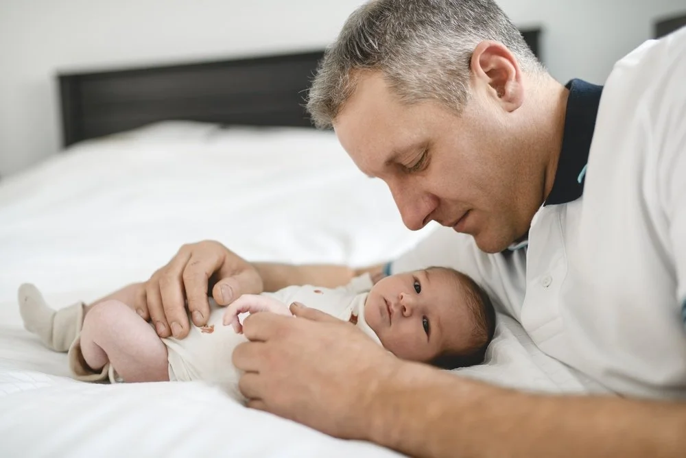 Parent caring for an infant, representing early childhood care and the importance of genetic testing for earlier diagnosis.