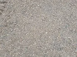 Close-up of a gravel surface with small stones and dirt.