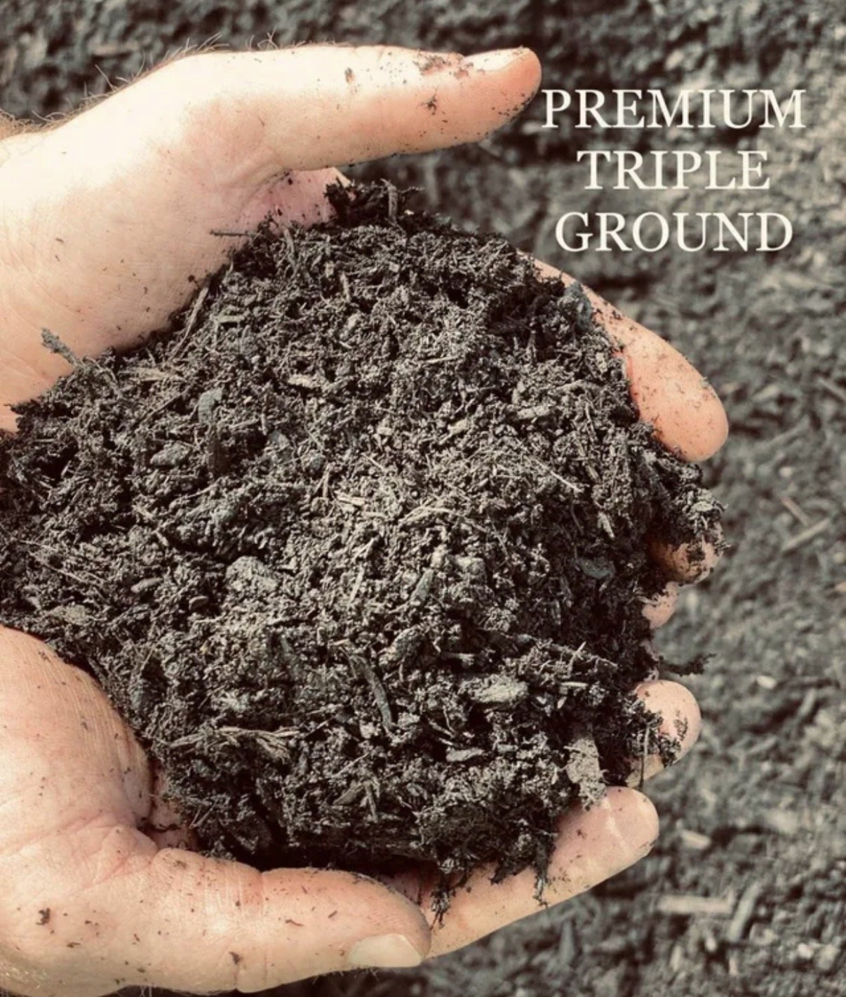 Person holding a handful of dark, rich soil labeled as 'Premium Triple Ground'.