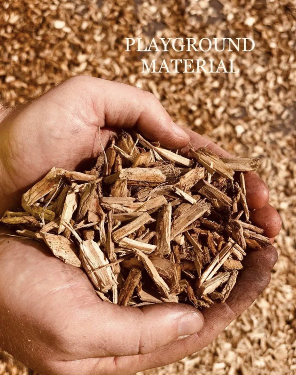 Close-up of a hand holding a handful of wood chips, with a background of more wood chips, and the text 'Playground Material'.