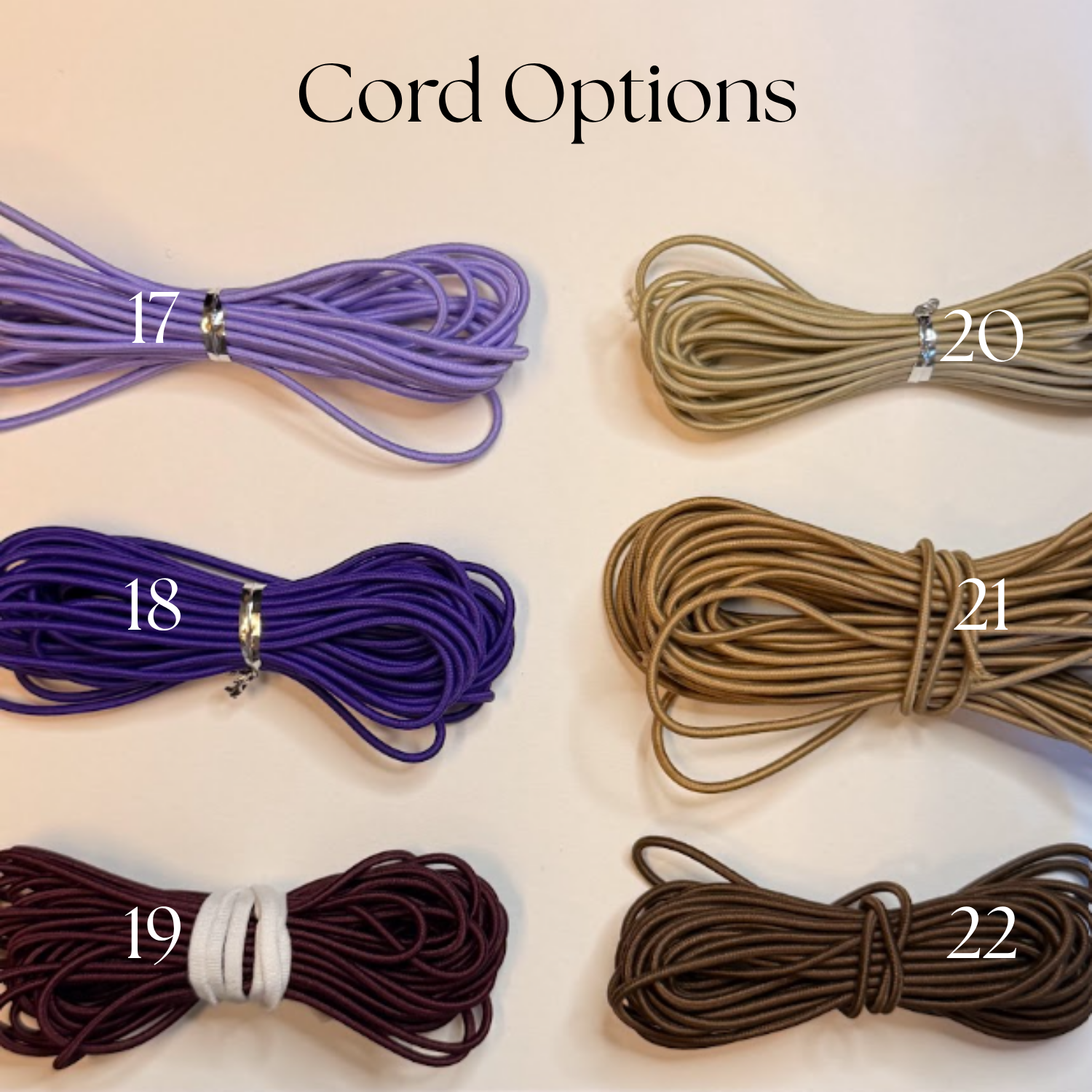 Multiple bundles of colored cords with numbers on a white surface, labeled as 'Cord Options'.