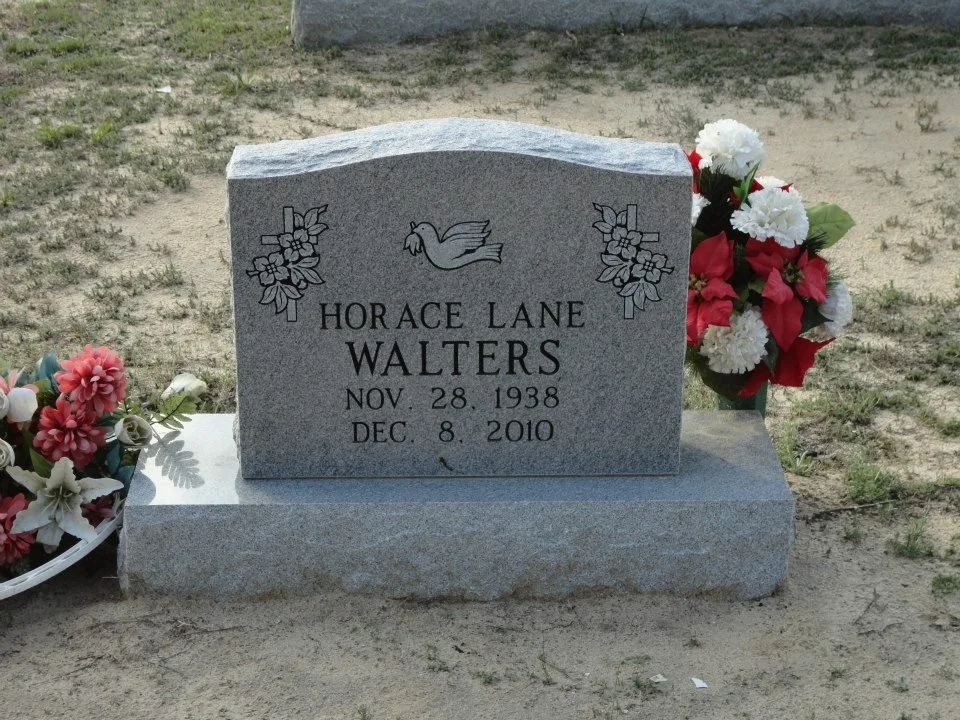 Gravestone with flowers, dedicated to Horace Lane Walters, born November 28, 1938, died December 8, 2010.