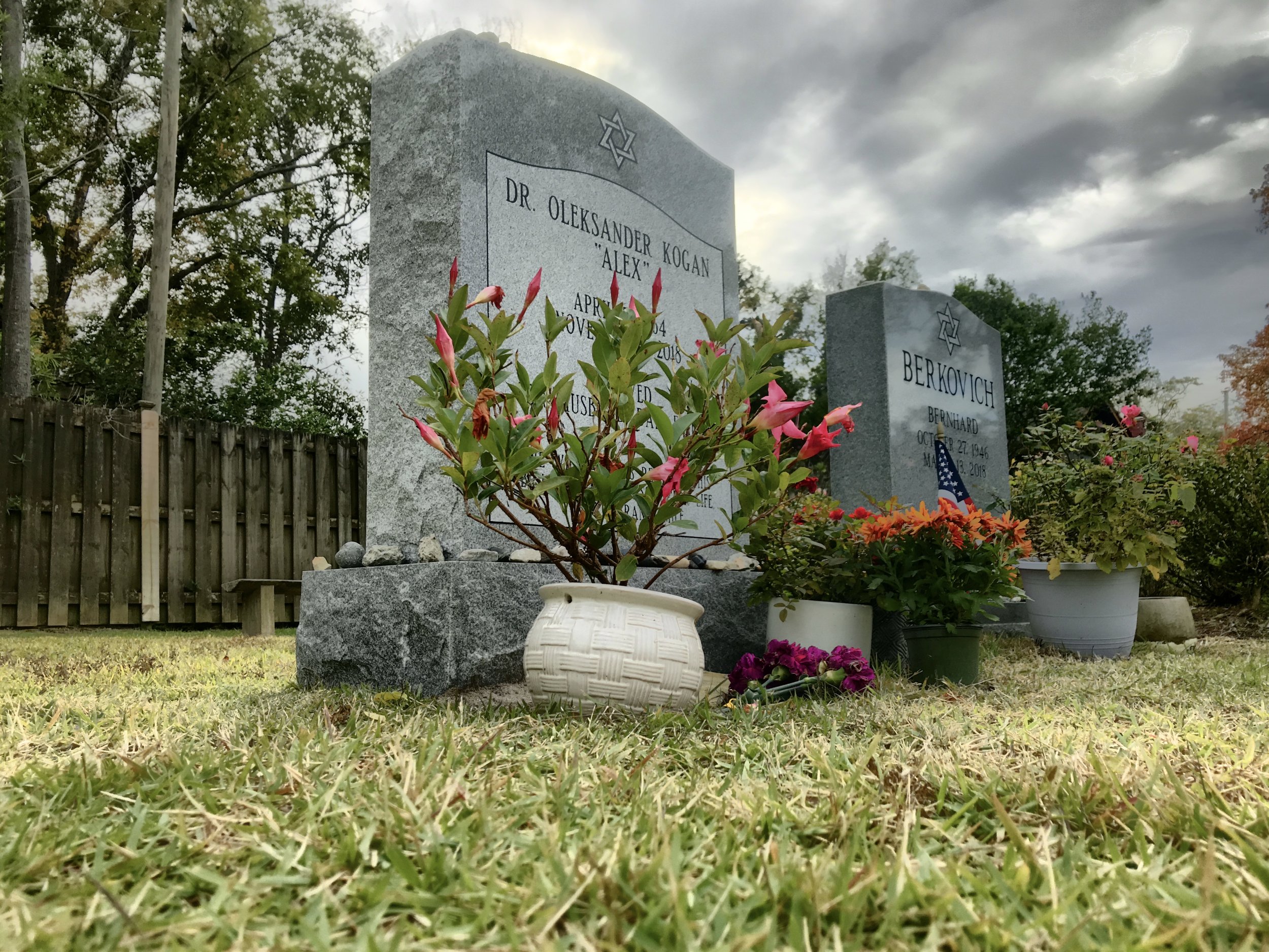 Gravestones in a cemetery with flowers. Located in Wilmington, North Carolina.