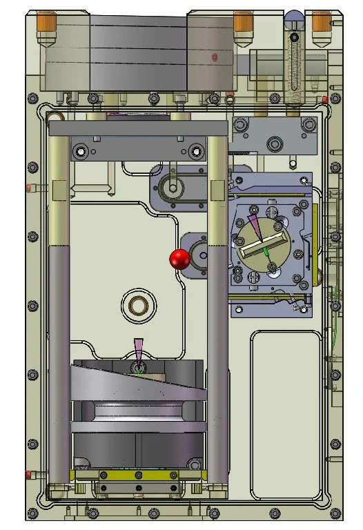 Diagram of a mechanical or electronic device showing internal components including gears, levers, and a clock face with hands.