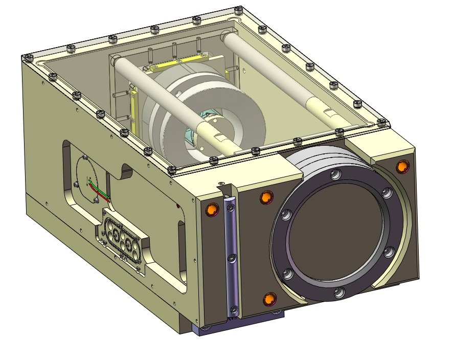 A technical illustration of a mechanical device with a transparent top cover, featuring a large circular component on the front, and cylindrical parts inside connected by rods, with wiring visible on the side.