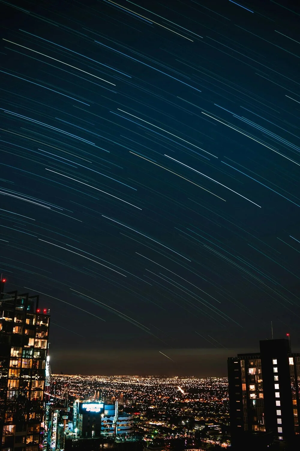 Photo of city night skyline and slow lapse stars | Property Management Accounting | Trust Accounting Compliance | Real Estate Bookkeeping