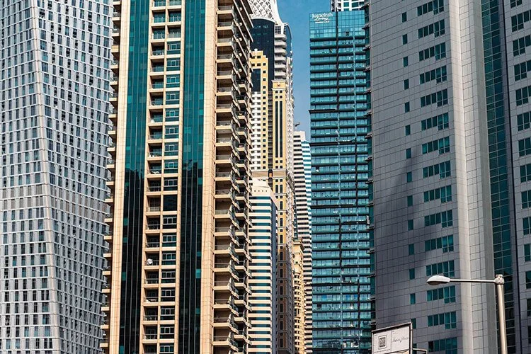 Tall skyscrapers in a city skyline with clear blue sky overhead. | Northstar Trust Accounting | HOA Financials | Monthly Reconciliation | AppFolio | DRE Compliance