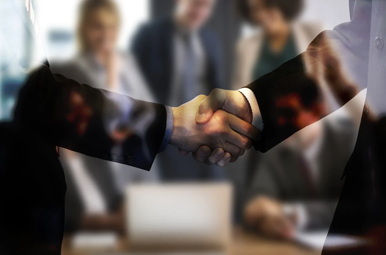 Photo of meeting behind handshake | Property Management & Compliance | AppFolio & Software Specialization | HOA & Association Management |  Fractional Leadership & Audit Recovery