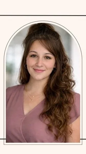Portrait of a young woman with long, wavy brown hair, wearing a mauve top and subtle jewelry, smiling at the camera.
