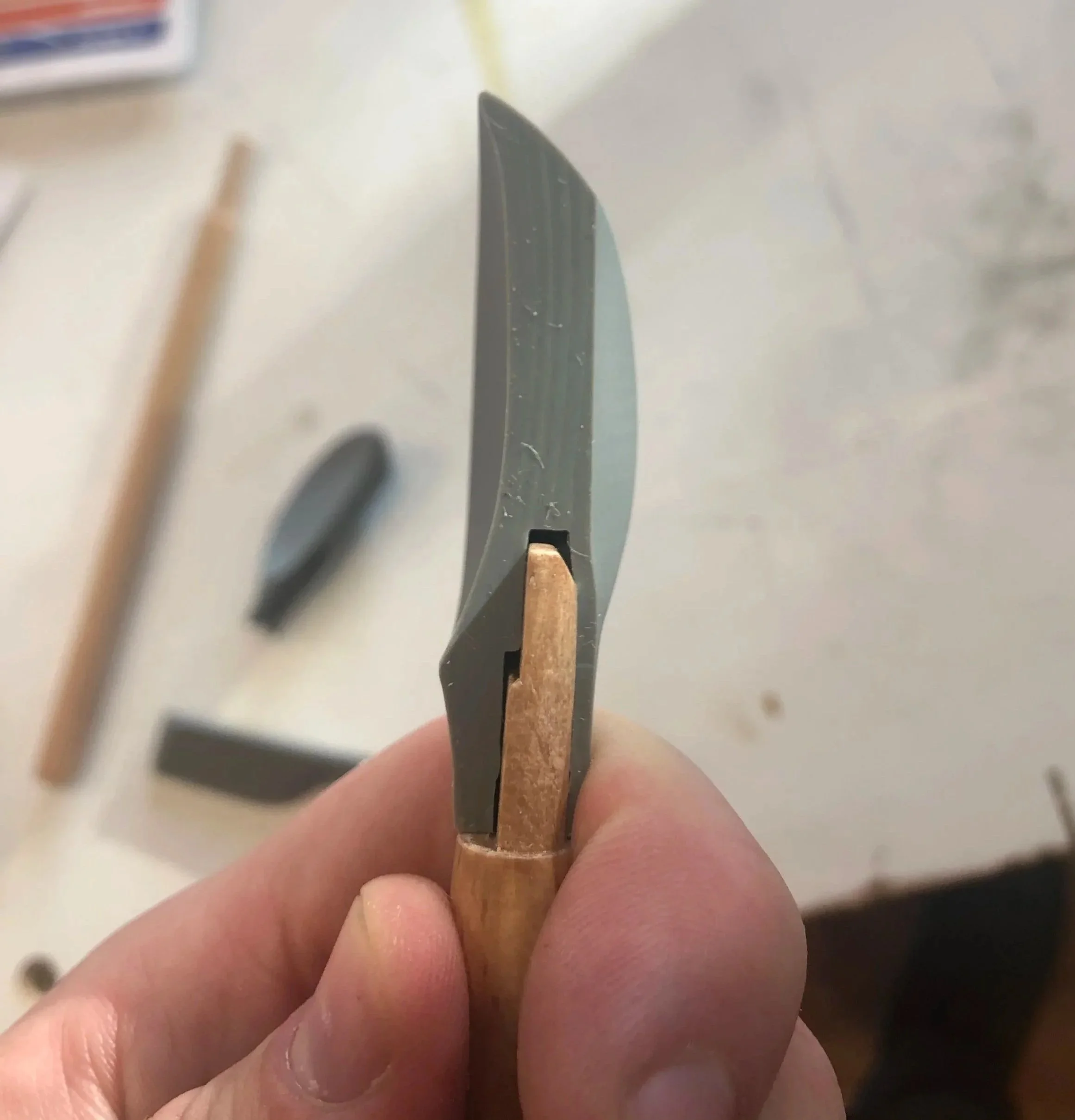Close-up of a person's hand holding a spoon detail for manufacturing