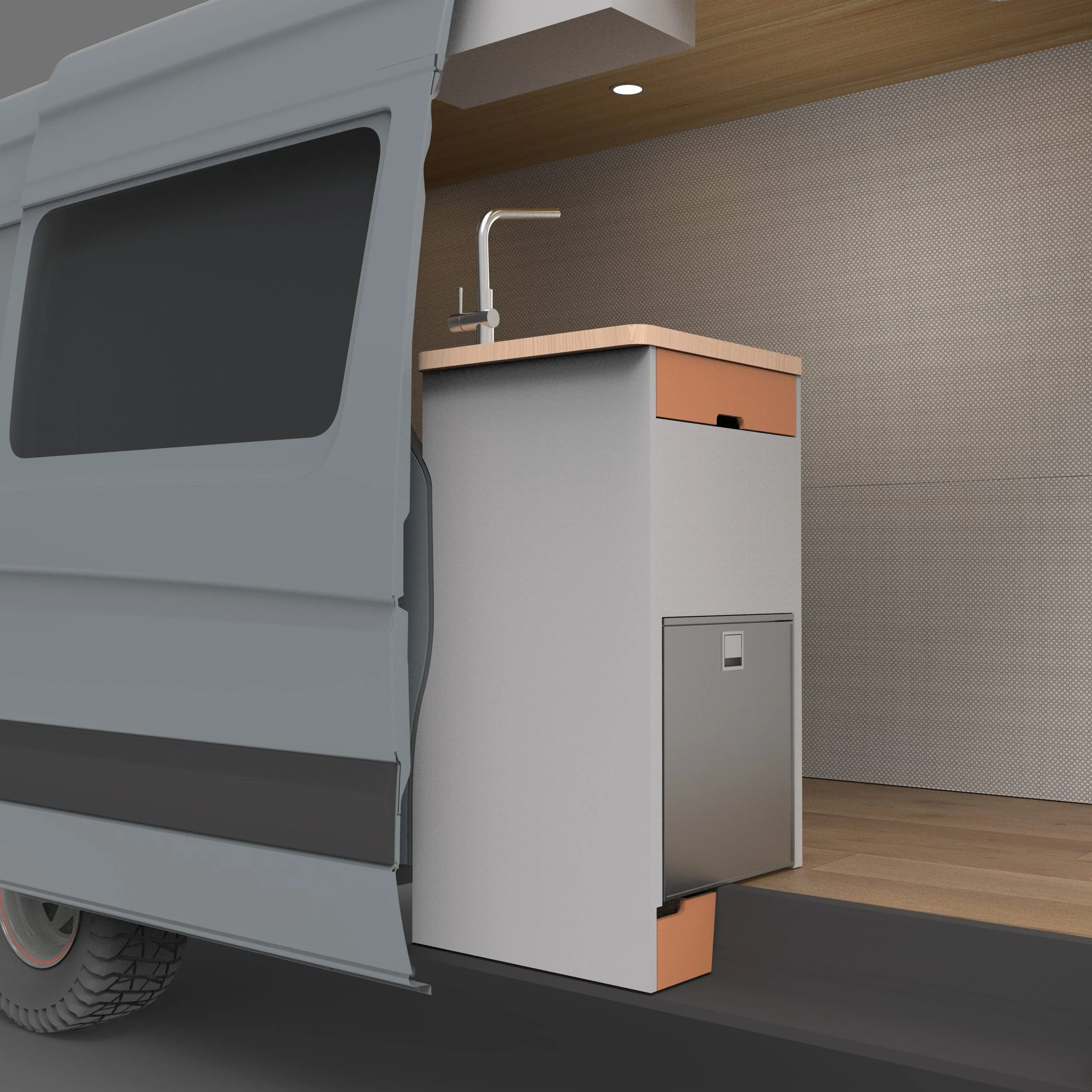 A close-up view of the lower part of a modern kitchen truck with a grey body, black tires, and a lifted hatch revealing a kitchen interior with a sink, a small cabinet with an orange drawer, a wooden countertop, and a textured wallpapered wall.