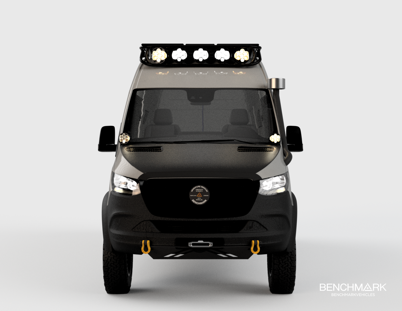Front view of a black utility van equipped with off-road accessories, including a roof-mounted LED light bar, a snorkel on the right side, and yellow tow hooks on the front bumper, with the Benchmark Vehicles logo on the bottom right corner.