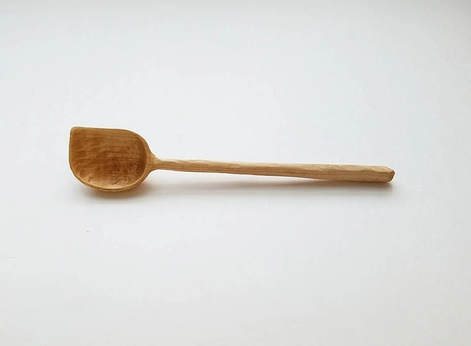 Wooden spoon on a white background.