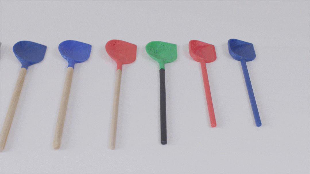 Colorful spatulas with wooden handles laid out on a white surface, in blue, red, green, and black colors.