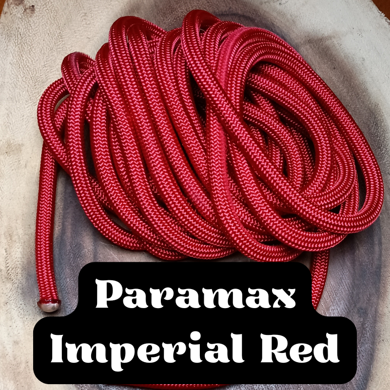 A coiled bundle of red and white patterned shoelaces on a grayish surface, with a label that reads "Paramax Imperial Red."