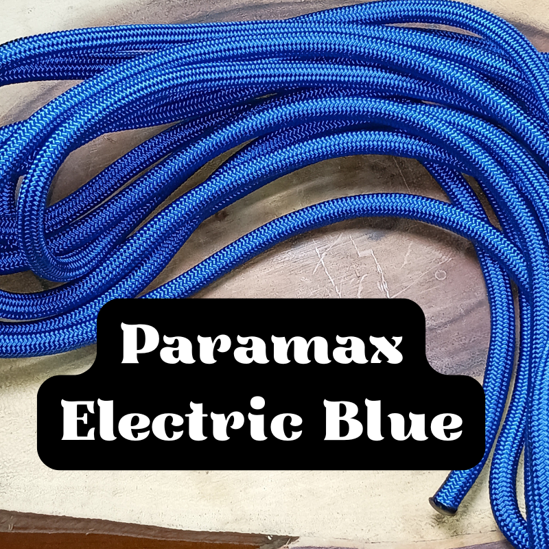 A bundle of blue braided cables labeled as 'Paramax Electric Blue' resting on a wooden surface.
