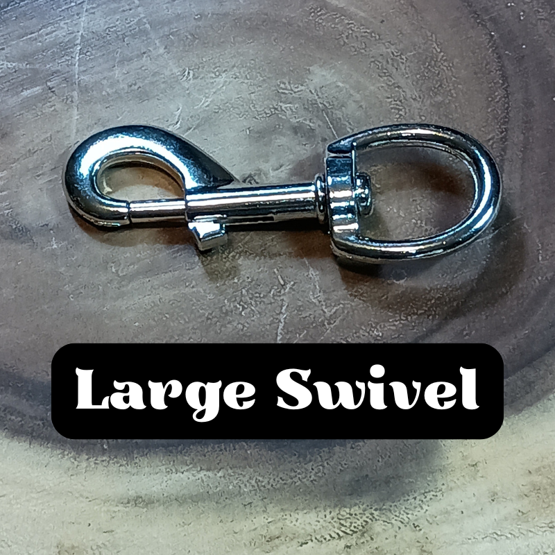 Close-up of a large silver swivel hook on a wooden surface.