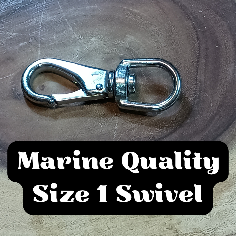A metallic marine-quality Size 1 swivel with a clip on one end, resting on a wooden surface.