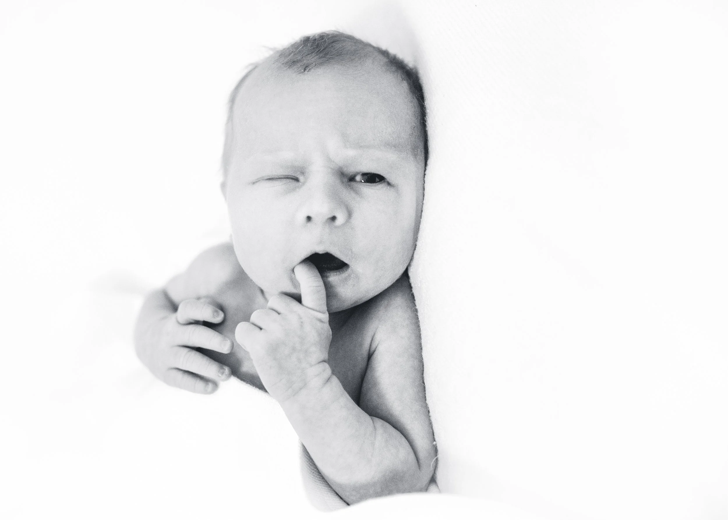 Newborn baby during a relaxed lifestyle newborn photography session at home in London by Kate See.