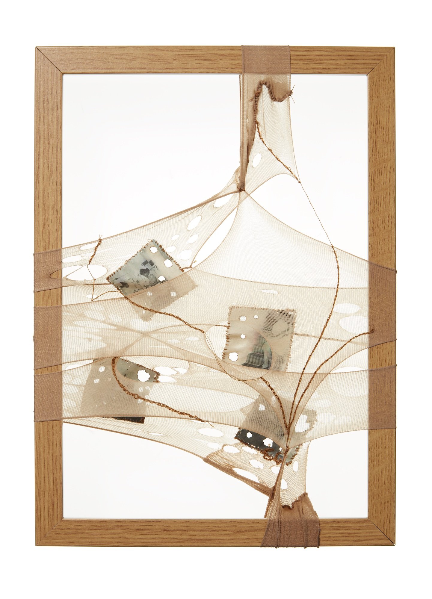 Untitled II, 2019, 23.5 x 32.5 x 3.5cm, burnout used nylon tights, vintage family photographs on tea-stained recycled paper, cotton thread  and wood photo frame 