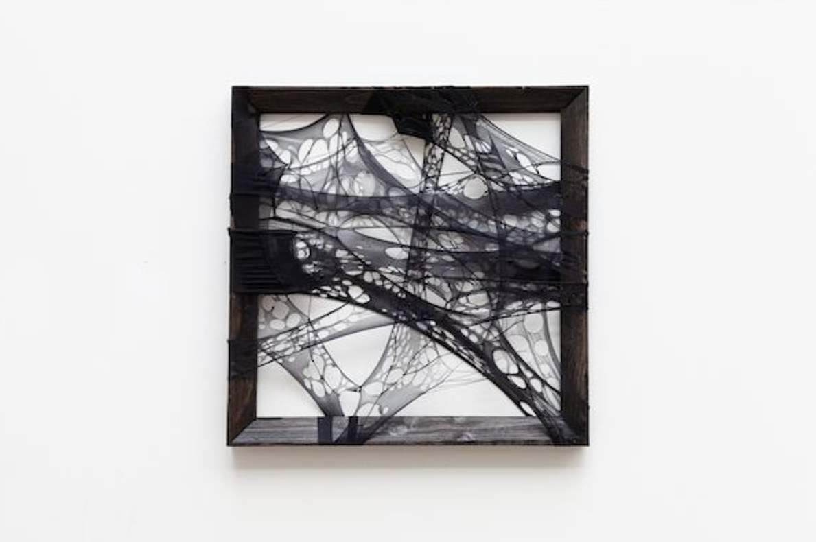 A cosmos within - the infinite black, SOURCE, 2021, 49.5 x 50 x 3.25cm, burnout used tights, recycled pet thread and eco-friendly water based acrylic paint on used empty canvas frame