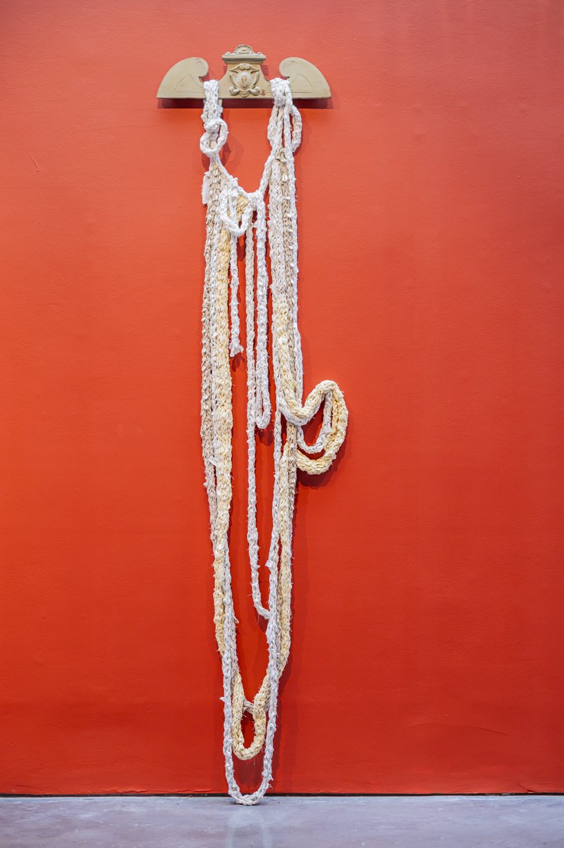 Xob (Plant) Altar I, 2023, 60 x 261cm, used cotton bedsheets, cowrie shells, cotton thread on vintage French pediment