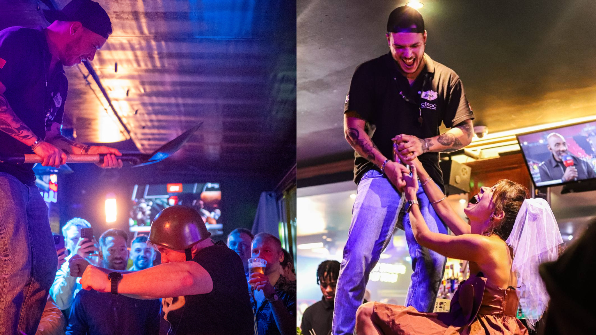 Cena de uma festa em um bar com várias pessoas, duas delas na dianteira. A pessoa à esquerda está com um capacete preto na cabeça, pintando uma caveira com uma arma na mão, enquanto a pessoa à direita, que usa boné e tem tatuagens nos braços, está sorrindo e sendo segurada por uma mulher que usa uma roupa que lembra traje de noiva, com um véu na cabeça. No background há várias pessoas assistindo, alguns segurando bebidas, e um monitor de TV que mostra uma pessoa falando ao microfone.