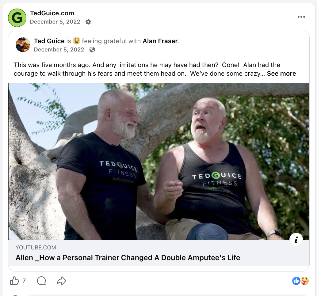 Two elderly men sitting on a large tree branch outdoors, both wearing black tank tops and talking to each other. The man on the left has a beard, and the man on the right has a mustache and is gesturing with his right hand.