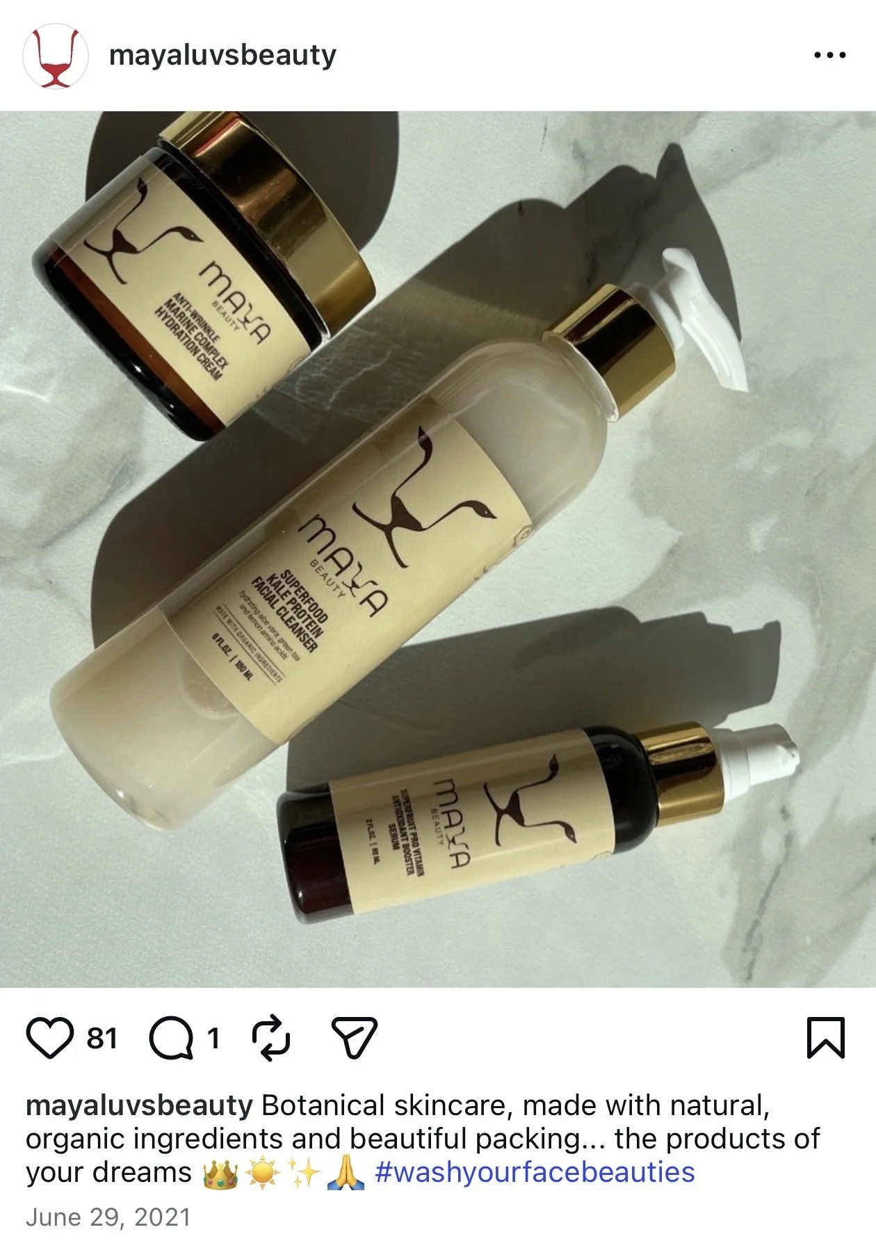 Three Mayla beauty skincare products, including a facial cleanser and a cream, are arranged on a white surface with shadows cast by sunlight.