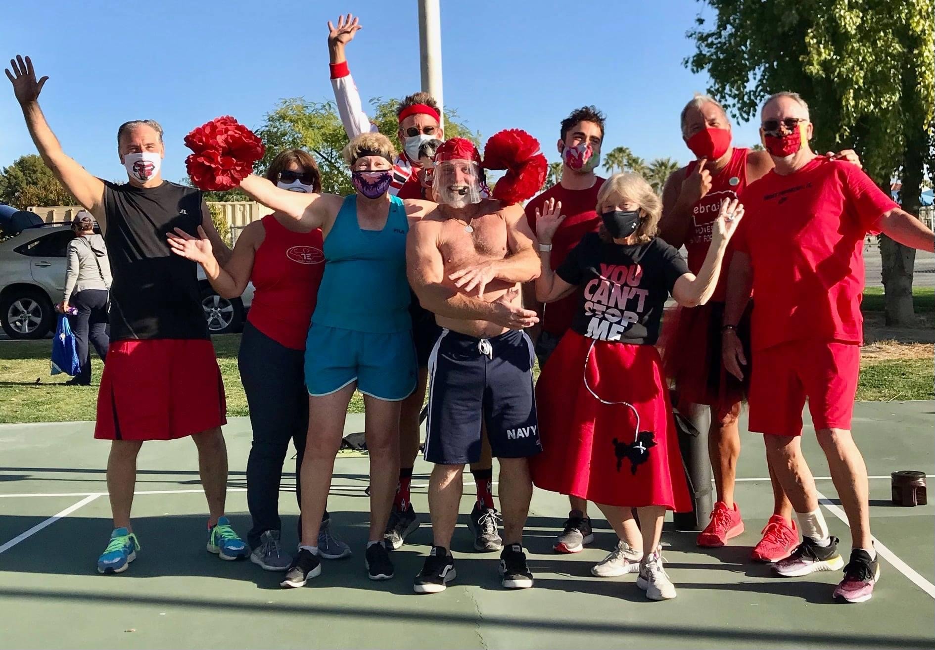 Ted's G-Force workout crew at Ruth Hardy Park in Palm Springs helping people over 50 get fit! Group of twelve people standing on a basketball court outdoors, many wearing red and black.
