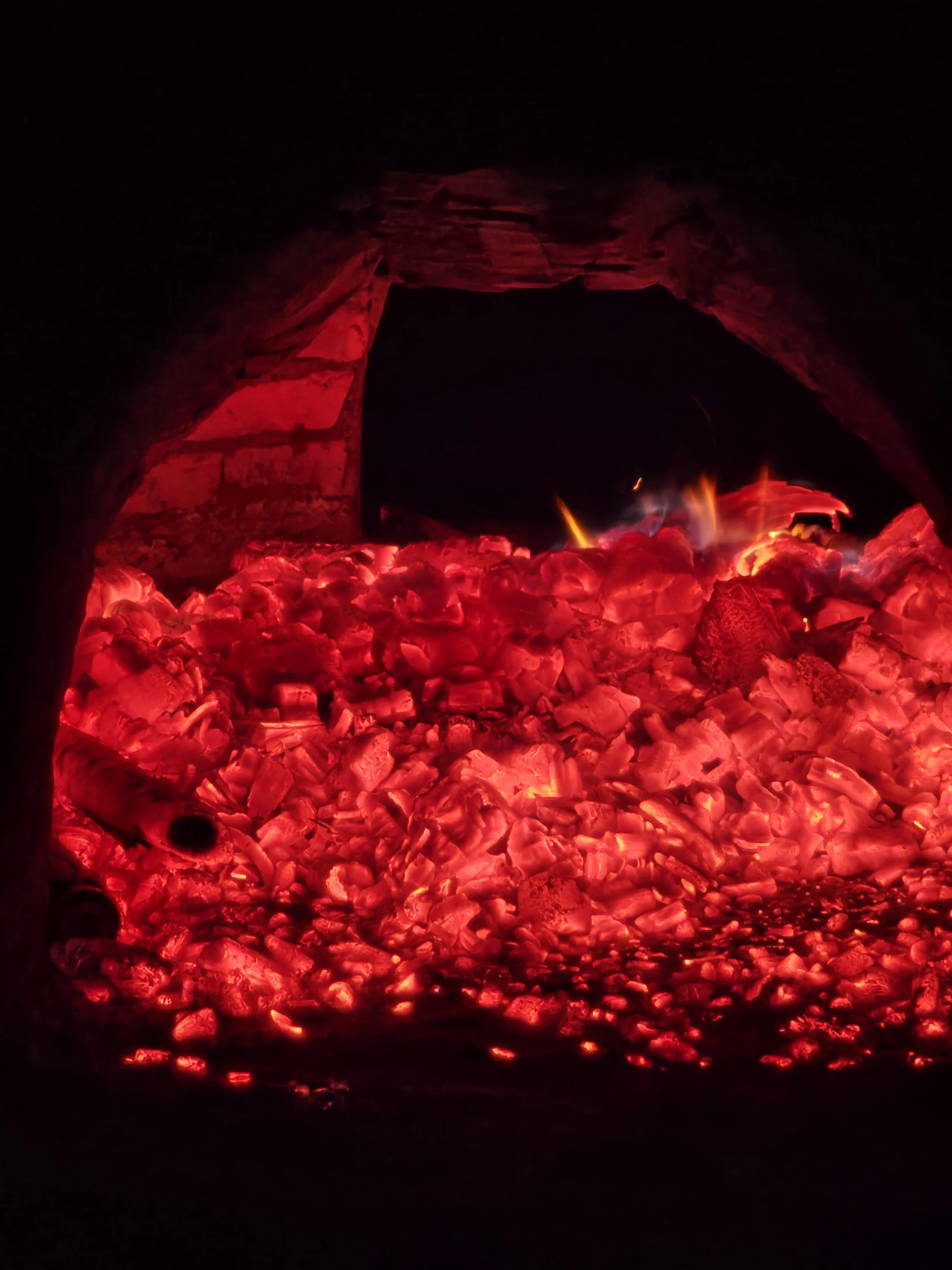 Glowing red and orange hot embers inside a tatakua.  Traditional Guarani oven.  Find out more about The Chaco Vendetta on markwodika.com