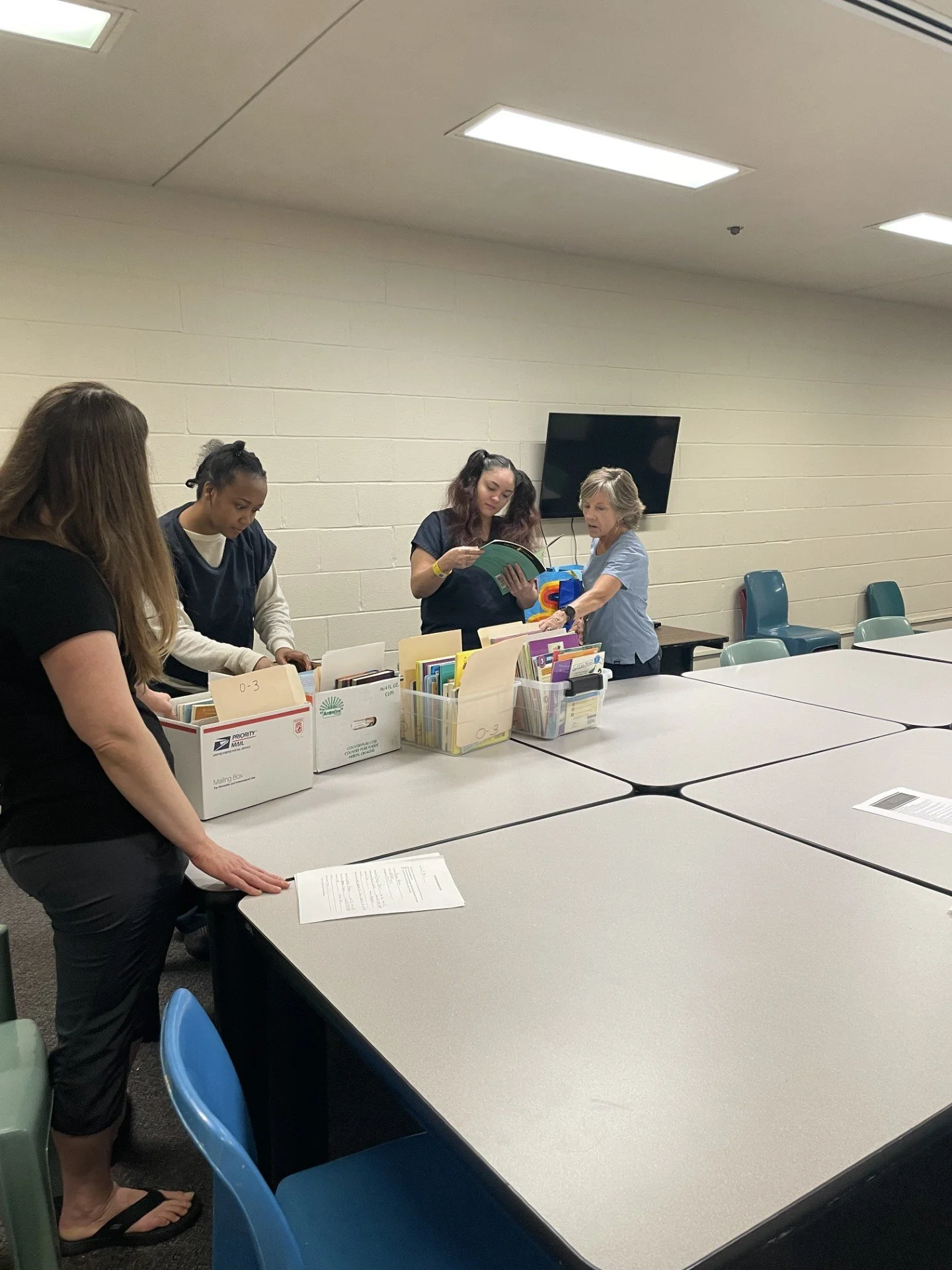 Volunteer helping with storybook women's program. 