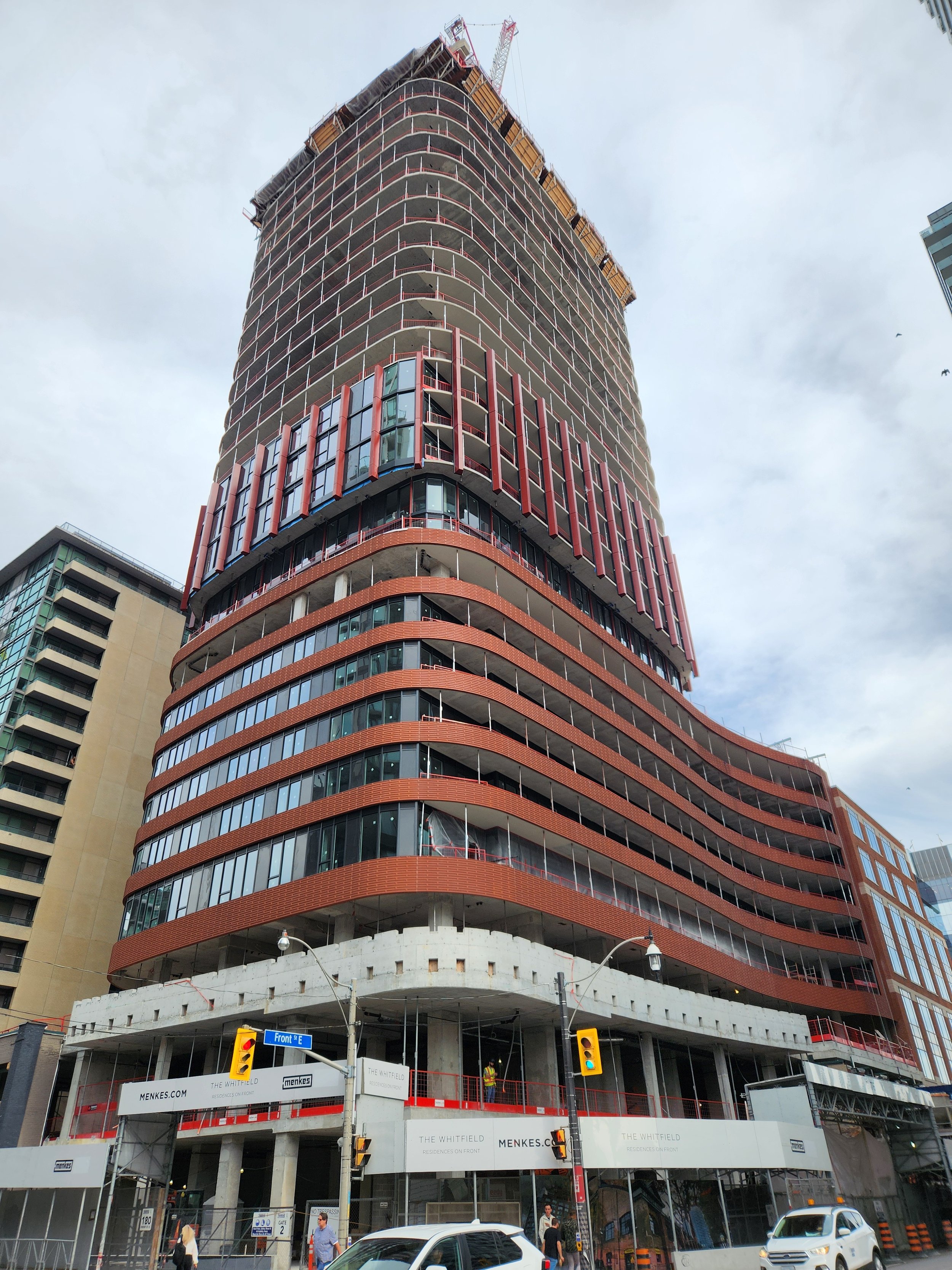 Curved high-rise masonry exterior after staining