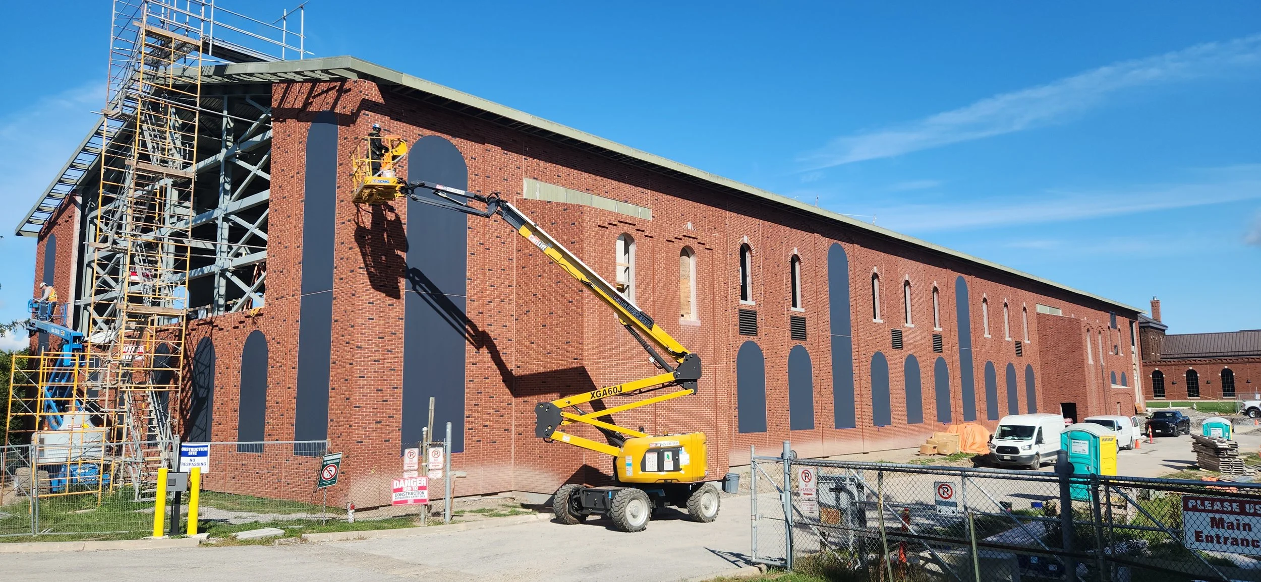 Commercial brick building restoration with a lift on site