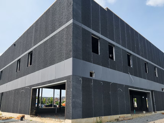 Dark masonry building surface prepared with clear primer