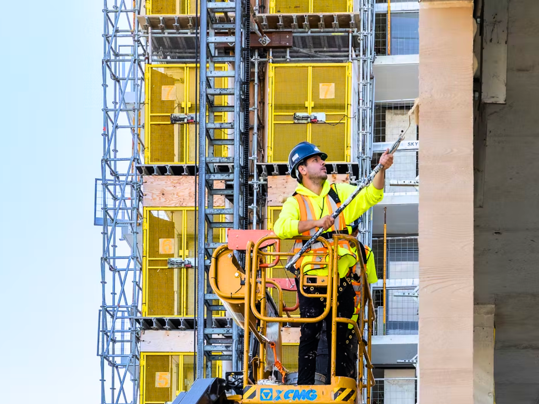 ColourFix worker on a lift at a construction site