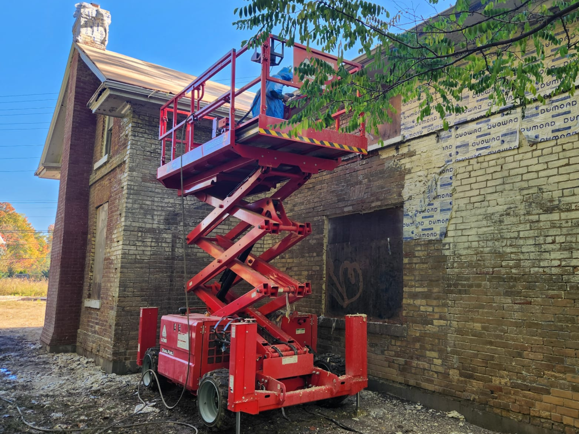 Painted brick building before paint removal