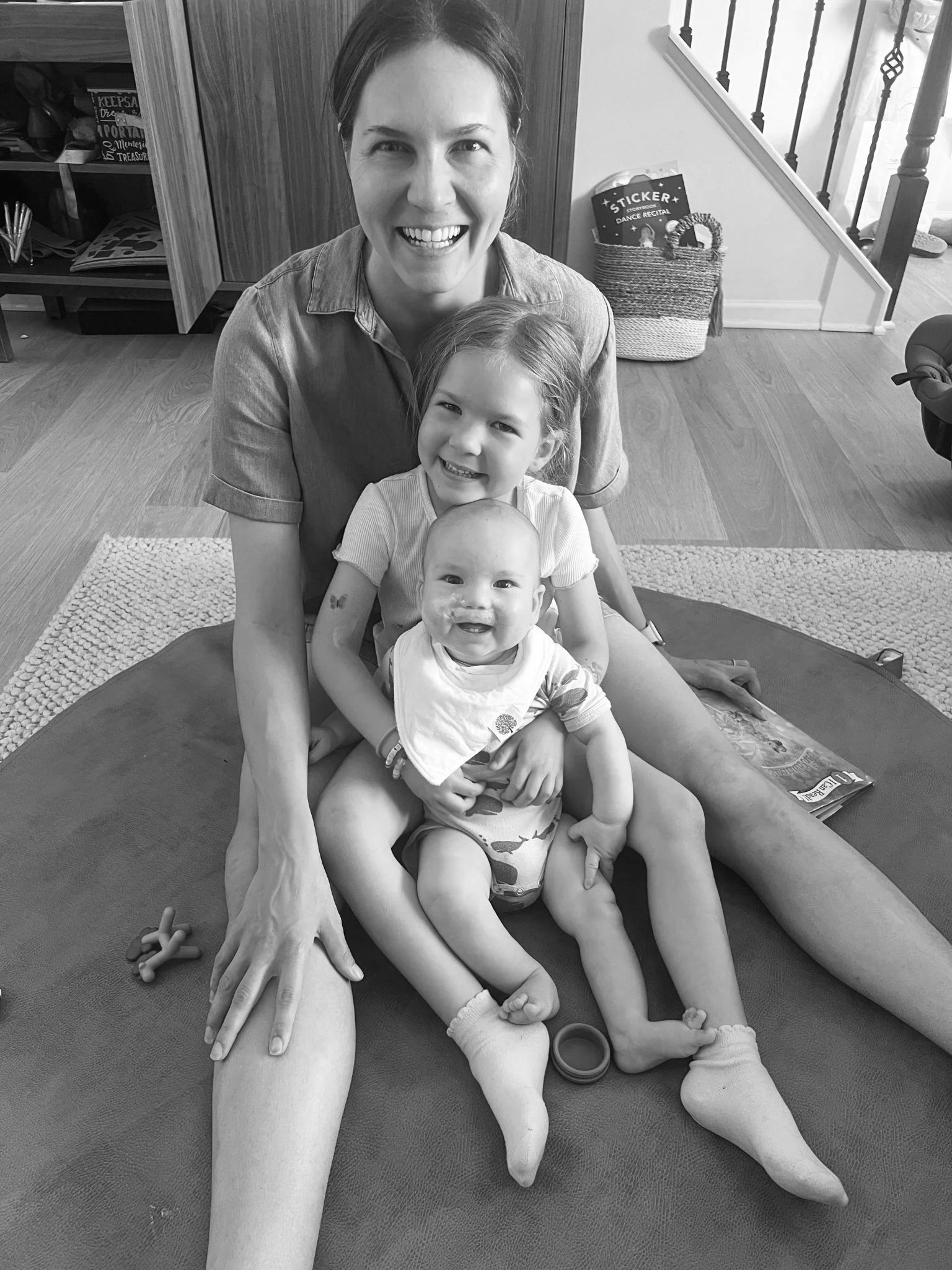 mother sitting with two children on her lap