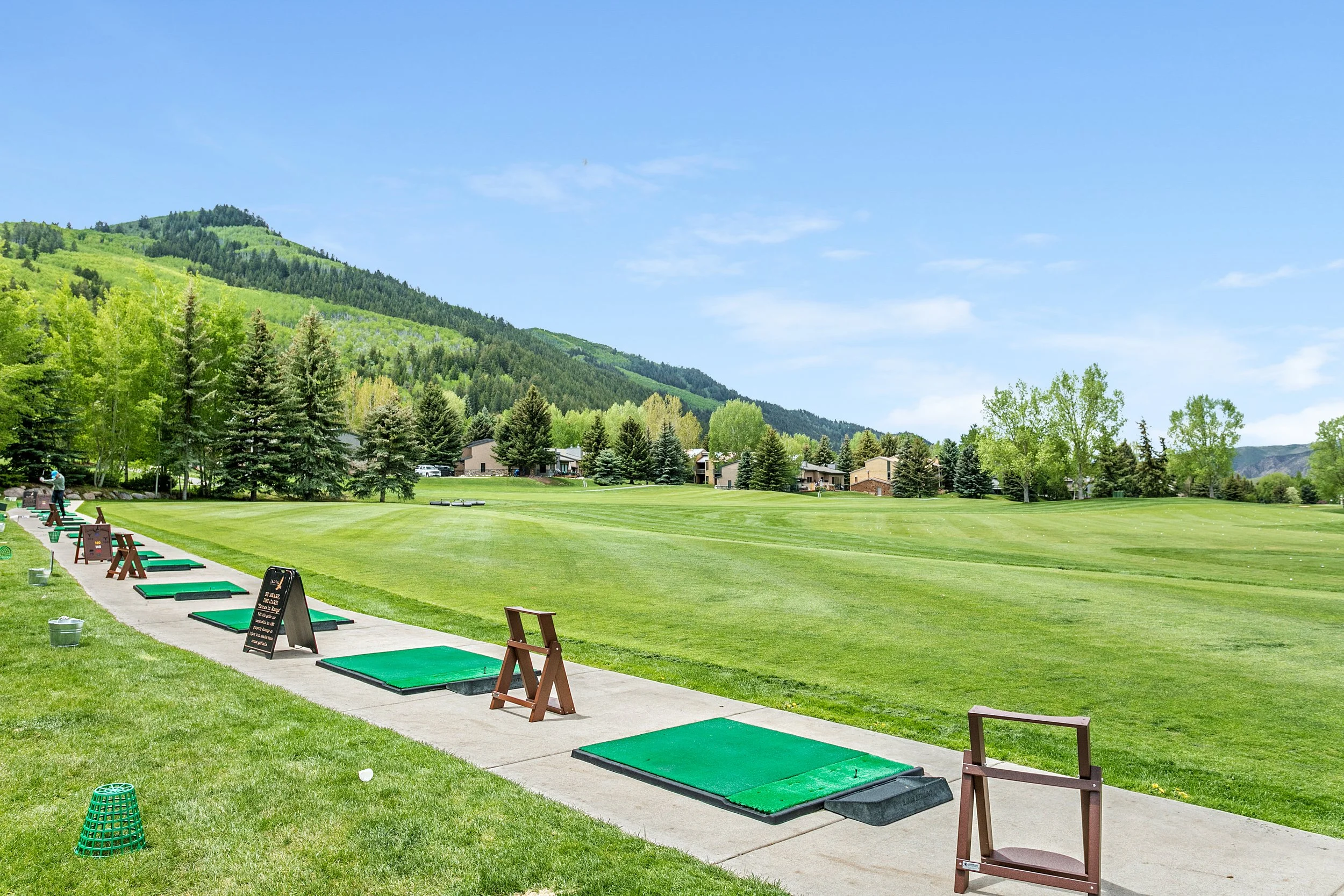 A scenic golf driving range highlighting the beauty of Vail Valley and the lifestyle represented by Danielle Huidekoper, LIV Sotheby's International Realty.