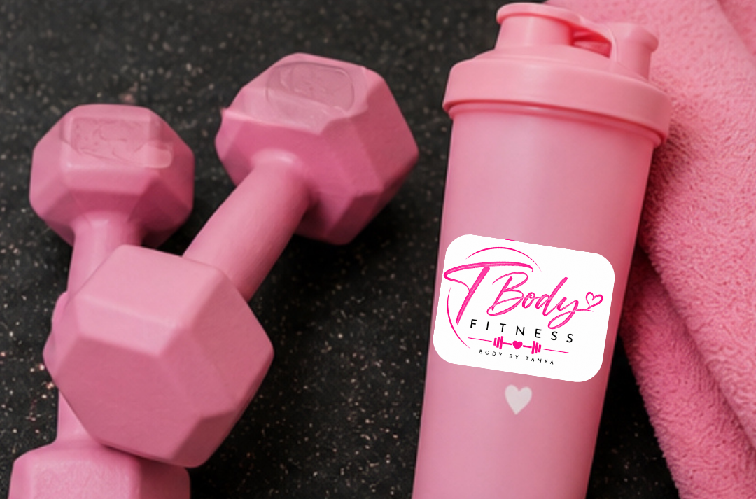 Pink water bottle with a fitness logo, pink dumbbells, and a pink towel on a black surface.