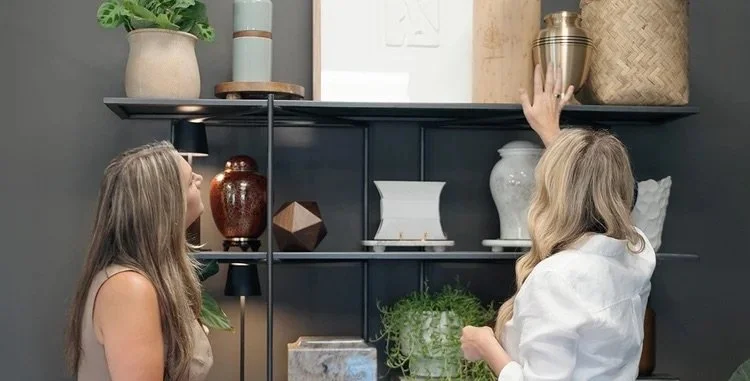 Two women browsing VIA Cremation Services urns and keepsakes for memorials in Redding, CA