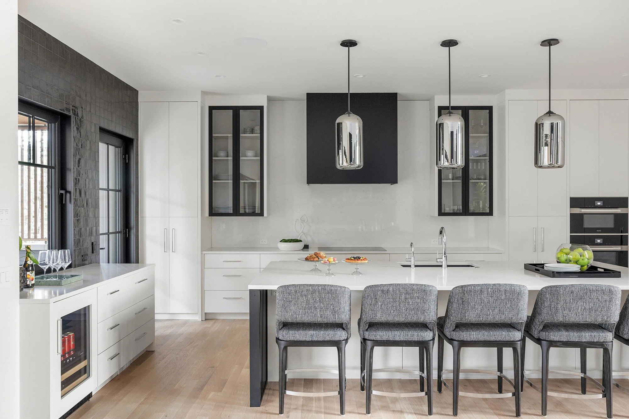 Modern kitchen with white cabinets and black accents