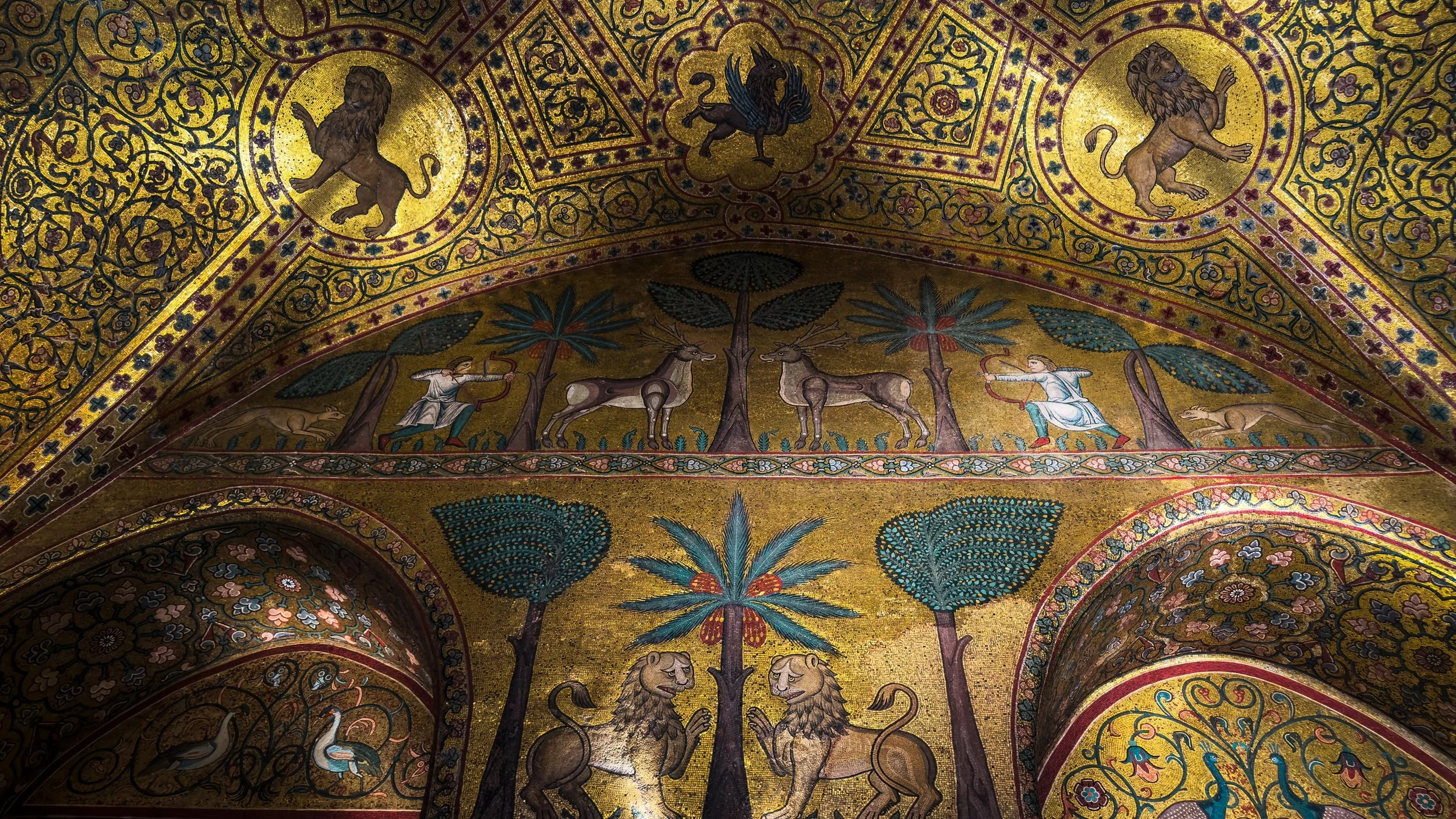 Gold mosaics with lions, palm trees and hunting figures in the Sala di Ruggero at Palazzo dei Normanni in Palermo.