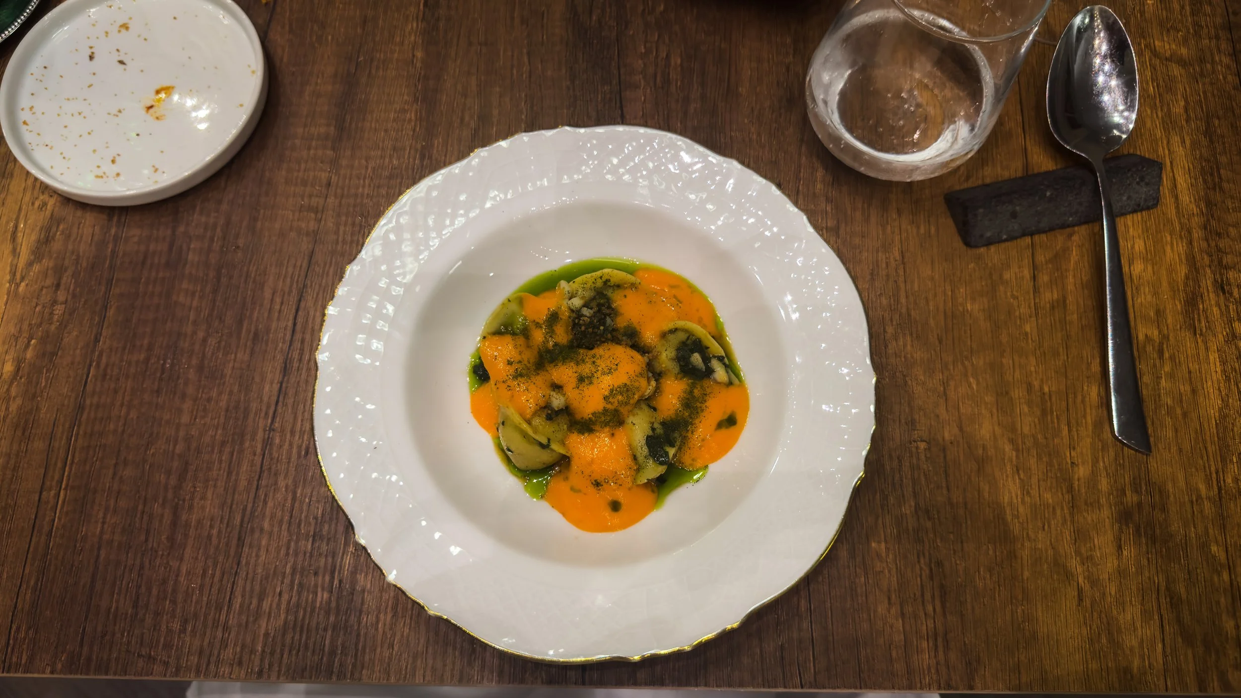 Plin di calamari at ALI3I in Palermo, served with pepper extract, lemon gel and crispy guanciale.