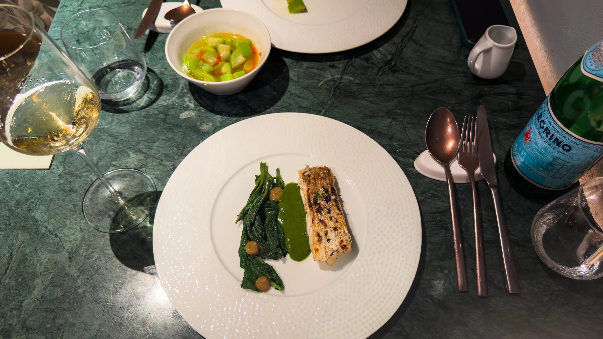 Grilled catch of the day served with tenerumi and green sauce at Rimessa Dragotto in Palermo.