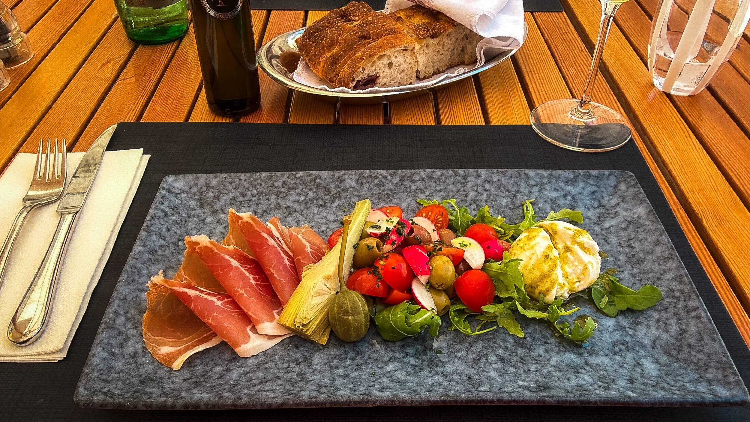 Dalmatian prosciutto with burrata, cherry tomatoes, olives and artichoke at Fish Restaurant Proto in Dubrovnik.