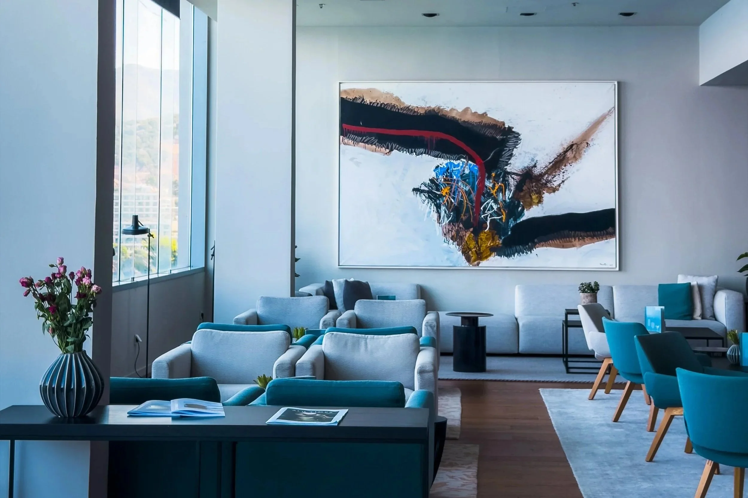 Contemporary lobby lounge at Hotel Dubrovnik Palace with blue seating and a large abstract artwork